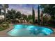 Stunning pool at night with landscape lighting at 4528 E Hobart St, Mesa, AZ 85205