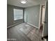 Bright bedroom with wood-look floors and window blinds at 9431 E Coralbell Ave # 32, Mesa, AZ 85208