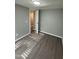 Bedroom with wood-look floors and access to hallway at 9431 E Coralbell Ave # 32, Mesa, AZ 85208