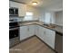 Modern kitchen with white cabinets, granite counters and stainless steel appliances at 9431 E Coralbell Ave # 32, Mesa, AZ 85208
