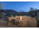 Peaceful backyard patio with fire pit and mountain views at 11233 E Butherus Dr, Scottsdale, AZ 85255