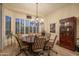 Formal dining room with large table, chandelier, and built-in hutch at 11233 E Butherus Dr, Scottsdale, AZ 85255