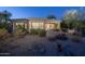 Back exterior view of house with desert landscaping and patio at 11233 E Butherus Dr, Scottsdale, AZ 85255
