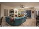Comfortable living room with teal sectional sofa and hardwood floors at 11233 E Butherus Dr, Scottsdale, AZ 85255