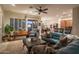 Bright living room with hardwood floors, open floor plan, and access to patio at 11233 E Butherus Dr, Scottsdale, AZ 85255