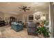 Spacious living room with hardwood floors, fireplace and large TV at 11233 E Butherus Dr, Scottsdale, AZ 85255