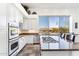 Well-equipped kitchen featuring white cabinets and granite countertops at 11440 E Winchcomb Dr, Scottsdale, AZ 85255