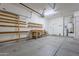 Garage interior with built-in shelving at 12702 W Dove Wing Way, Peoria, AZ 85383