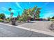 House exterior showcasing a large driveway and landscaping at 13802 N 64Th Pl, Scottsdale, AZ 85254