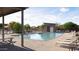 Community pool with lounge chairs and covered seating at 14917 W Hackamore Dr, Surprise, AZ 85387