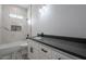 Clean bathroom with single vanity, tub, and marble tile at 22538 W Pecan Rd, Buckeye, AZ 85326