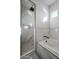 Bathroom with walk-in shower, soaking tub, marble tile, and niche at 22538 W Pecan Rd, Buckeye, AZ 85326