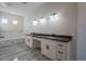 Elegant bathroom with double vanity, soaking tub, and marble tile at 22538 W Pecan Rd, Buckeye, AZ 85326