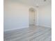 Simple bedroom with gray tile flooring and large window at 22538 W Pecan Rd, Buckeye, AZ 85326