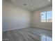 Bright bedroom with large window and gray tile flooring at 22538 W Pecan Rd, Buckeye, AZ 85326