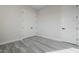Empty bedroom with double doors and gray tile floor at 22538 W Pecan Rd, Buckeye, AZ 85326