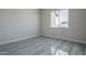 Bright bedroom with large window and gray tile floor at 22538 W Pecan Rd, Buckeye, AZ 85326