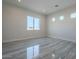 Spacious bedroom with large window and gray tile flooring at 22538 W Pecan Rd, Buckeye, AZ 85326