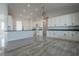 Modern kitchen with white cabinets, large island, and tile floors at 22538 W Pecan Rd, Buckeye, AZ 85326