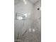 Walk-in shower with marble tile and pebble floor at 22538 W Pecan Rd, Buckeye, AZ 85326