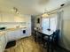 Kitchen with white cabinets, gas stove and dining area at 305 S Val Vista Dr # 204, Mesa, AZ 85204