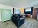 Living room with dark leather couches and wood-look floors at 305 S Val Vista Dr # 204, Mesa, AZ 85204