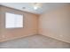 Simple bedroom with ceiling fan and window at 5659 S 239Th Dr, Buckeye, AZ 85326