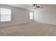 Spacious bedroom with ceiling fan and neutral carpeting at 5659 S 239Th Dr, Buckeye, AZ 85326