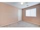 Light peach bedroom with ceiling fan and window at 5659 S 239Th Dr, Buckeye, AZ 85326