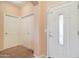 Bright entryway with neutral colored walls and carpet at 5659 S 239Th Dr, Buckeye, AZ 85326