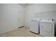 Laundry room with washer, dryer, and shelving at 5659 S 239Th Dr, Buckeye, AZ 85326