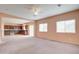 Spacious living room with open floor plan and kitchen views at 5659 S 239Th Dr, Buckeye, AZ 85326