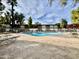 Community pool with patio furniture and surrounding landscaping at 6125 E Indian School Rd # 167, Scottsdale, AZ 85251