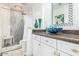 Elegant bathroom with a large vanity, a walk-in shower, and decorative accents at 6722 W Piute Ave, Glendale, AZ 85308