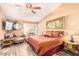 Spacious main bedroom with a comfortable bed and seating area at 6722 W Piute Ave, Glendale, AZ 85308