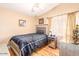 Bedroom with a plush bed, nightstand, and wood flooring at 6722 W Piute Ave, Glendale, AZ 85308