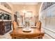 A formal dining room with a chandelier and fireplace at 6722 W Piute Ave, Glendale, AZ 85308