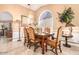 Formal dining area with ornate chairs and a stained glass window at 6722 W Piute Ave, Glendale, AZ 85308