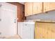 Laundry room with washer, dryer, and built-in cabinets at 6722 W Piute Ave, Glendale, AZ 85308
