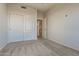 Spacious bedroom with carpet flooring and double door closet at 11021 W Tonto Ln, Peoria, AZ 85373