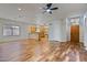 Open living room and kitchen with hardwood floors at 11021 W Tonto Ln, Peoria, AZ 85373