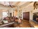 Relaxing living room with a leather couch and a built-in wooden cabinet at 11410 E Juan Tabo Rd, Scottsdale, AZ 85255