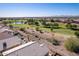 Aerial view of homes, golf course, and mountains at 11553 W Sonoran Ct, Surprise, AZ 85378
