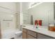 Clean bathroom with a tub shower, vanity, and mirror at 11553 W Sonoran Ct, Surprise, AZ 85378