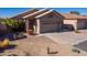 Two-car garage and front yard with desert landscaping at 11553 W Sonoran Ct, Surprise, AZ 85378