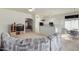Kitchen with white cabinets, breakfast bar, and living room view at 11553 W Sonoran Ct, Surprise, AZ 85378