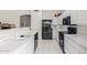 Modern kitchen featuring black appliances and white cabinetry at 11553 W Sonoran Ct, Surprise, AZ 85378