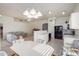 Open concept kitchen with breakfast bar and living room view at 11553 W Sonoran Ct, Surprise, AZ 85378