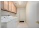 Laundry room with washer, dryer, cabinets and exterior access at 11553 W Sonoran Ct, Surprise, AZ 85378