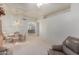 Living room with light carpet, leather couches, and dining area at 11553 W Sonoran Ct, Surprise, AZ 85378